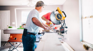 construction worker cutting flooring